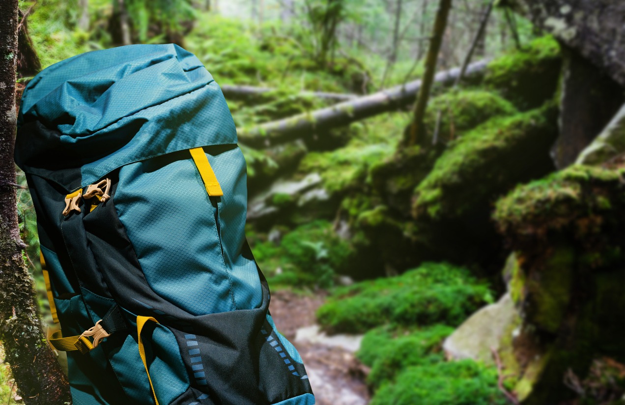 Large hiking blue backpack in forest