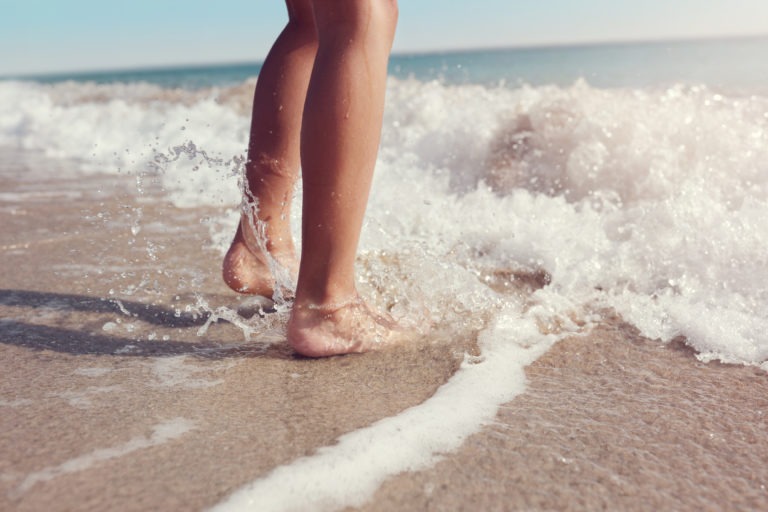 Jumping in the sea waves on the beach